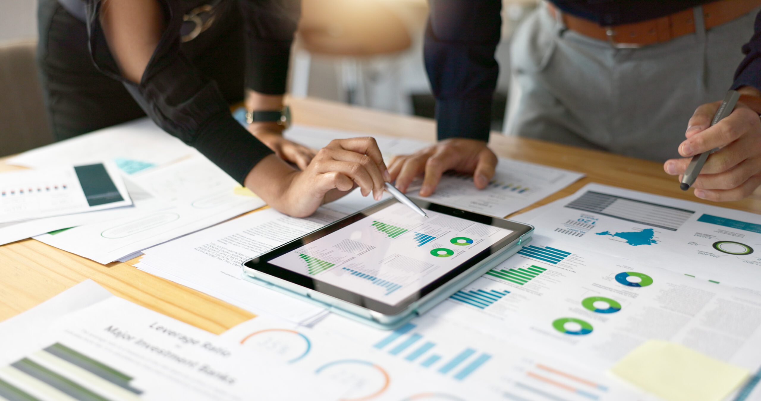 Business people, data analysis with tablet and paperwork, hands with online review in meeting and team with market research. Statistics, analytics dashboard and digital infographic with collaboration Business people, data analysis with tablet and paperwork, hands with online review in meeting and team with market research. Statistics, analytics dashboard and digital infographic with collaboration